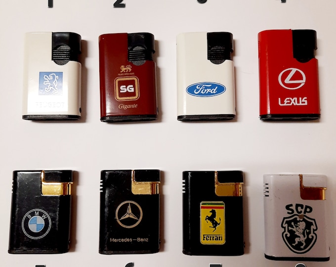 Vintage lighters. Metal lighters with logos of automobile brands